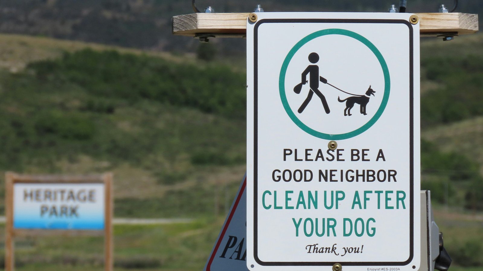 A sign that says please be a good neighbor clean up after your dog